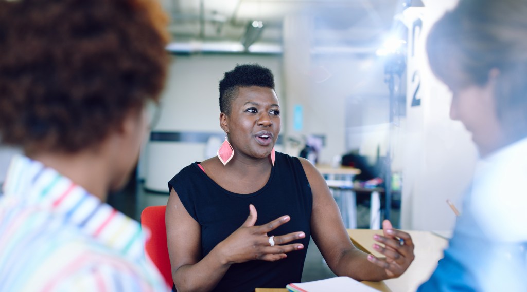 Candid picture of a Black woman leading a focus group.