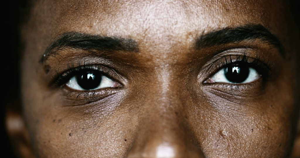 Close-up Black woman eyes macro staring at camera